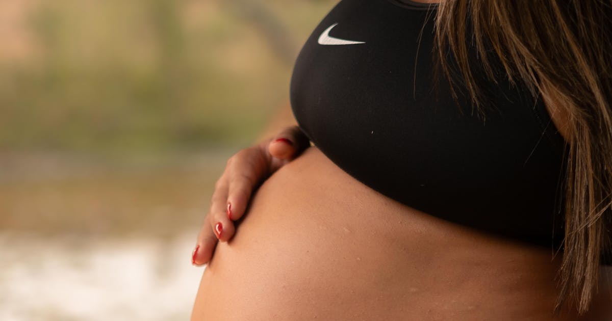 Blivande mamma utomhus i bekväma kläder